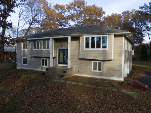 outside of small house for sale at maltz auctions in new york