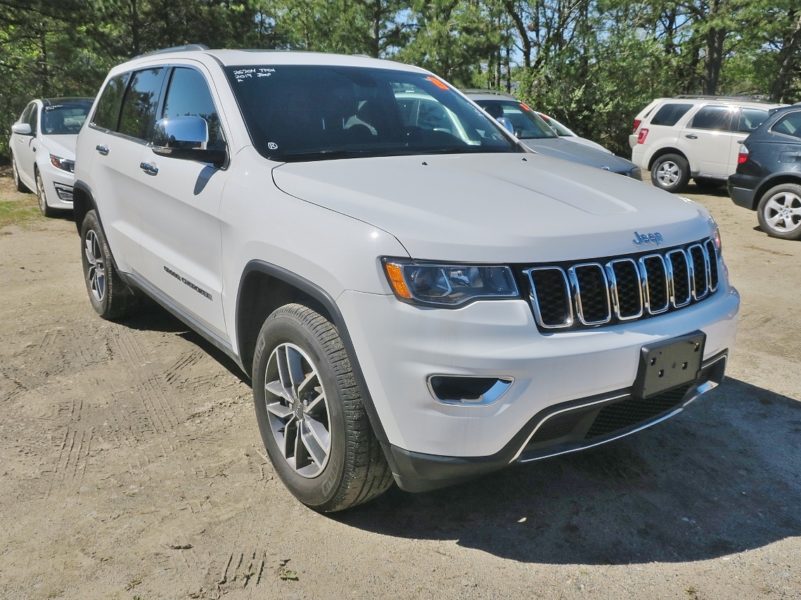 front of white jeep automobile for sale by maltz auctions in new york city