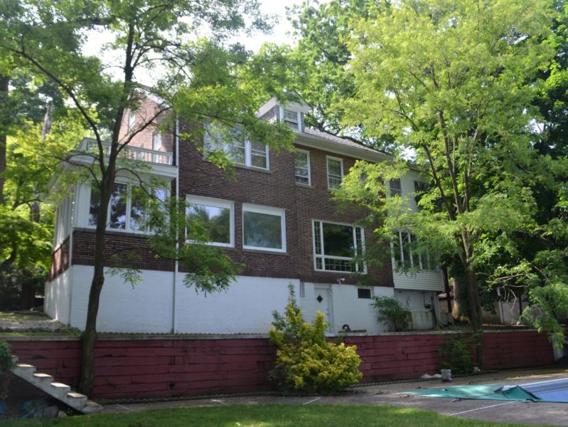 outside of brick home up for sale at maltz auctions