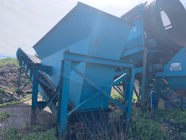 side of rusted construction equipment for sale by maltz auctions