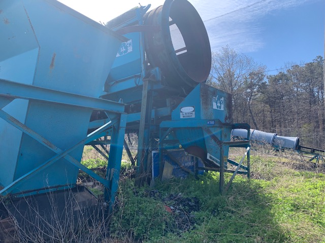 side of rusted construction equipment for sale by maltz auctions