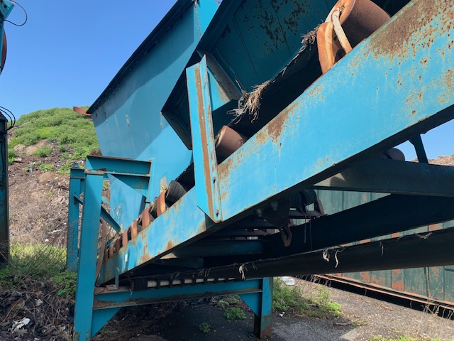 side of rusted construction equipment for sale by maltz auctions