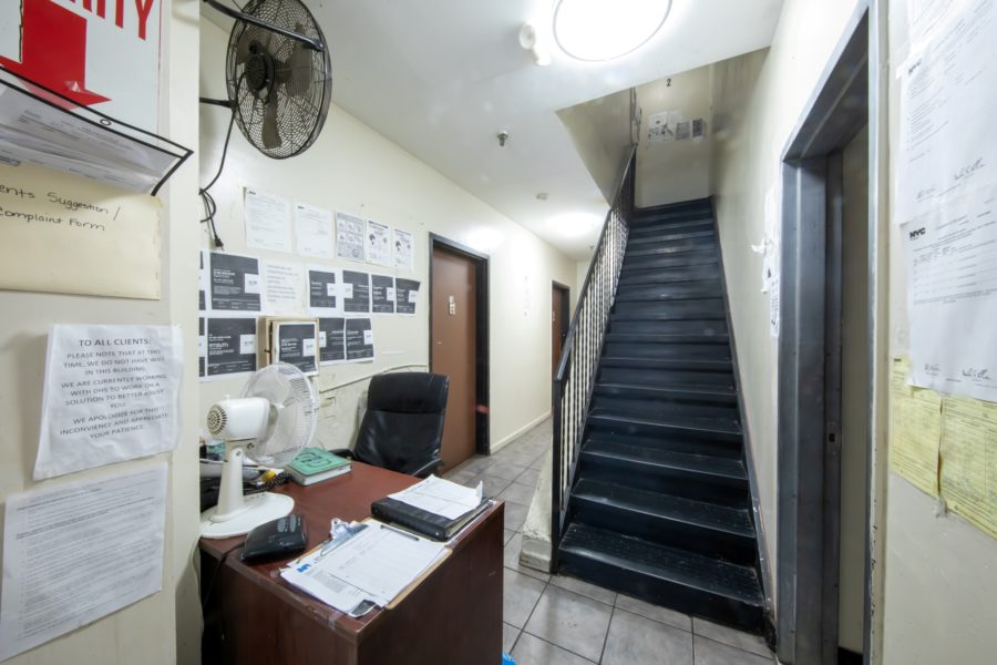 office space and hallway of 16 unit multifamily building for sale at maltz auctions