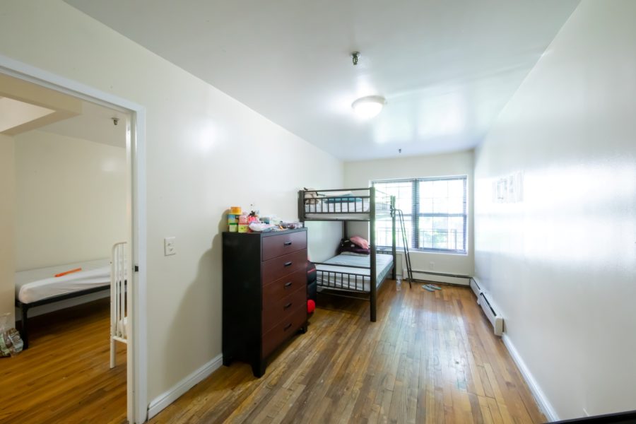 bedroom of 16 unit multifamily building for sale at maltz auctions