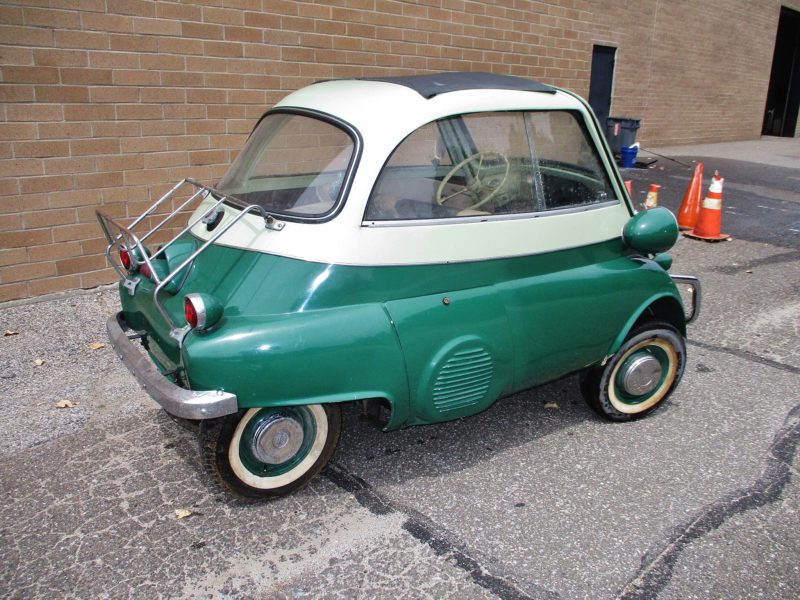 Side view of green and white vehicle up for auto auction at Maltz Auctions
