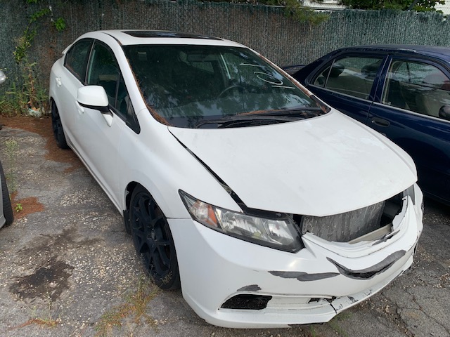White car sitting in parking lot up for auto auction at Maltz Auctions in New York City, New York