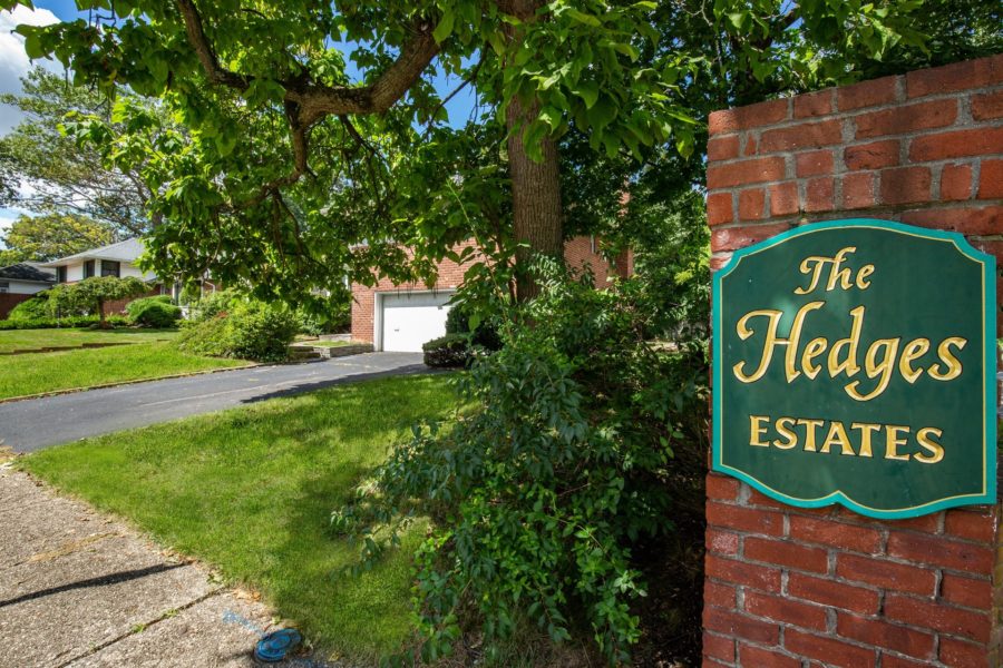 the hedges estates sign in front of house
